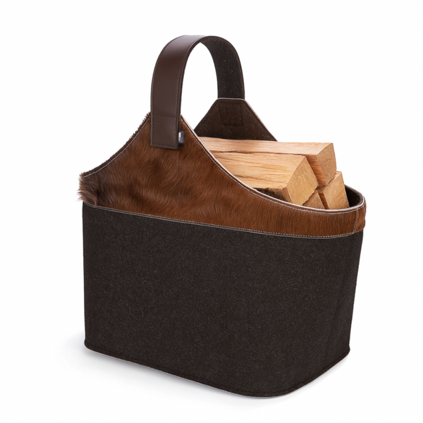 Holzkorb aus Filz mit braunem Kuhfell und Holzscheite gefüllt